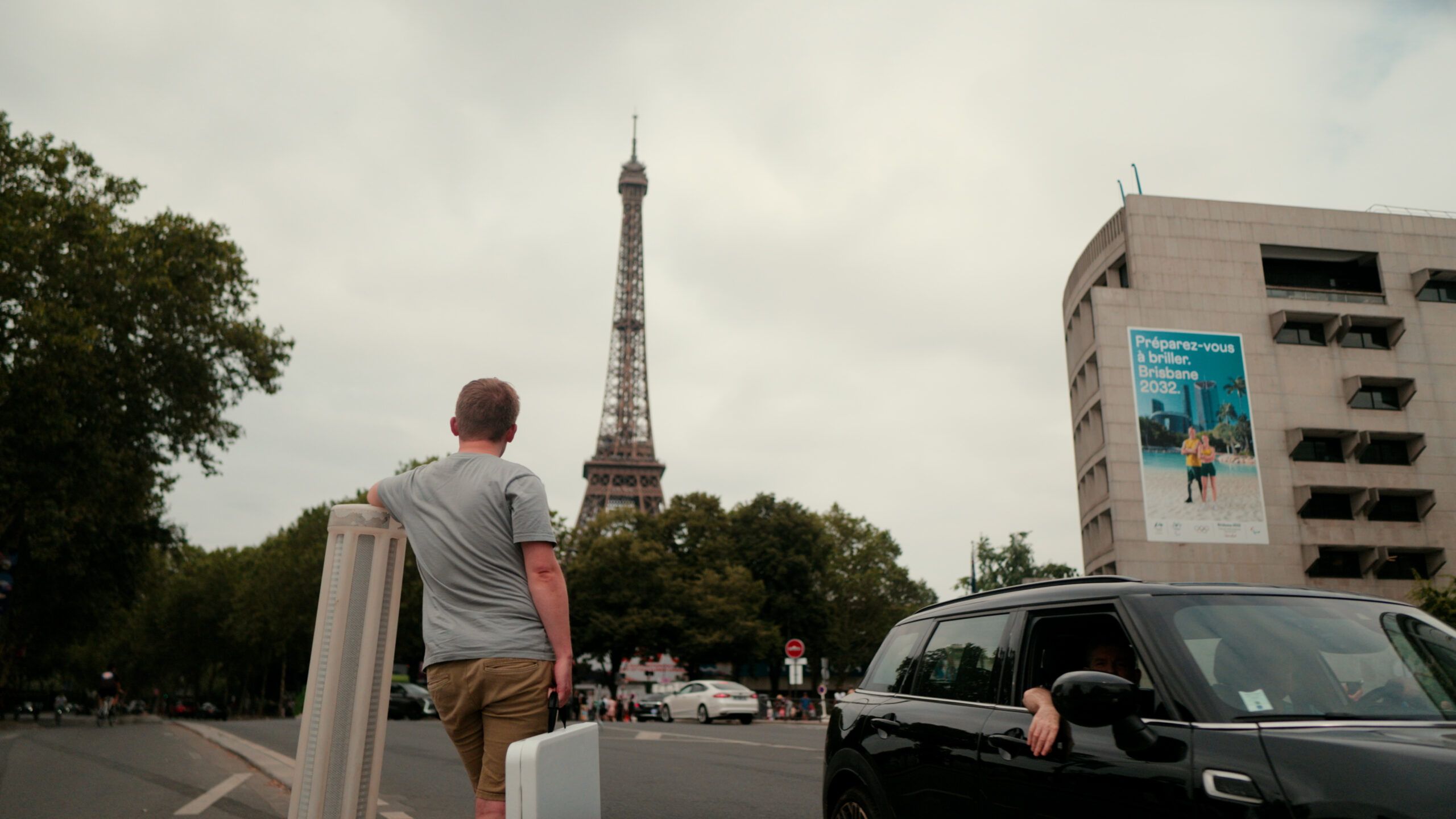 Tom Nicholas looks up at the Eiffel Tower in the distance.