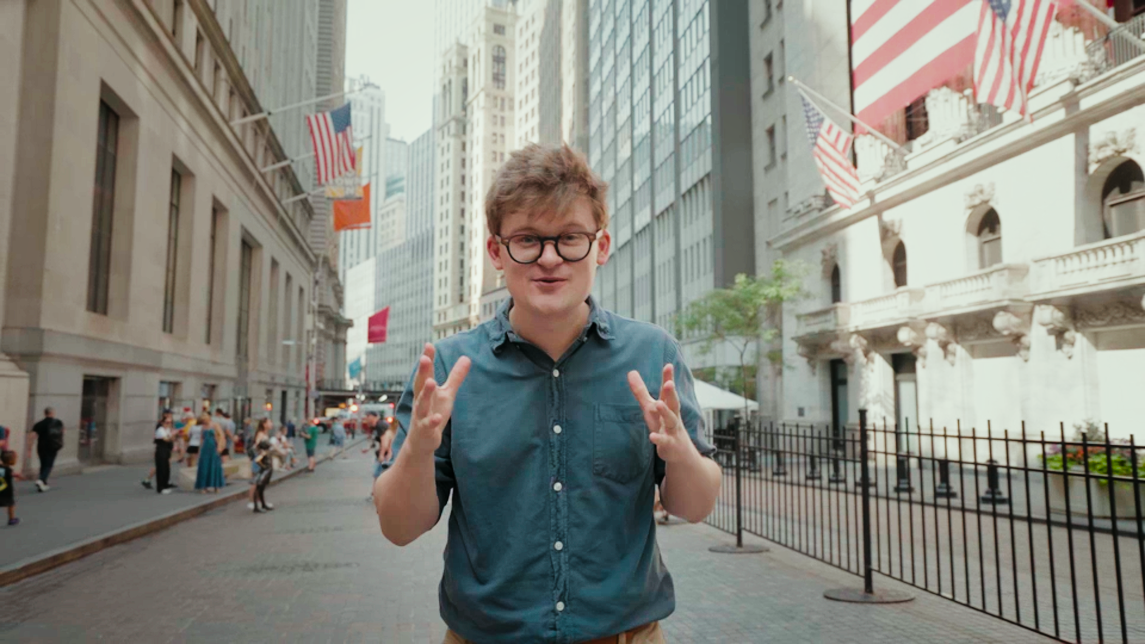 Tom Nicholas standing on Wall Street.